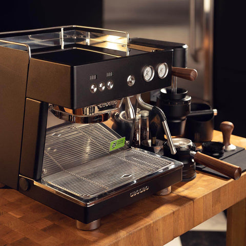 Black Ascaso Baby T espresso machine sitting on a kitchen counter.
